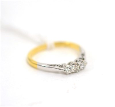 Lot 24 - An 18ct gold diamond three stone ring, finger size L