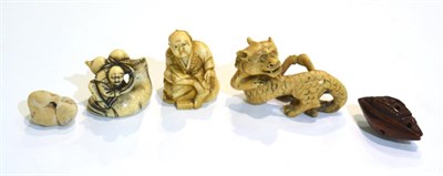 Lot 45 - Three Meiji period carved ivory netsukes, dragon, man with whale and seated man; also a carved...