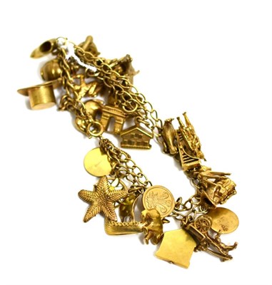 Lot 60 - A 9ct gold charm bracelet with twenty nine charms