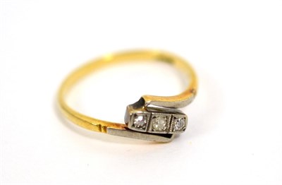 Lot 64 - A 9ct gold three stone diamond crossover ring