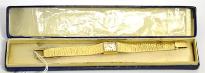 Lot 69 - A 9ct gold lady's wristwatch on a 9ct gold bracelet strap