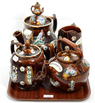 Lot 123 - A collection of Measham ware comprising two teapots, kettle and jug (damages)