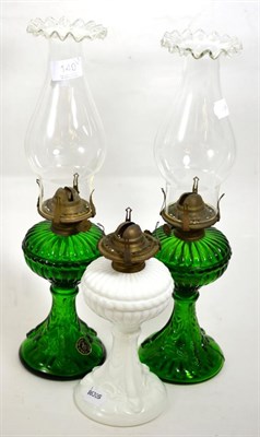 Lot 140 - A pair of Casa Pupo fish moulded green glass oil lamps and a milk glass oil lamp