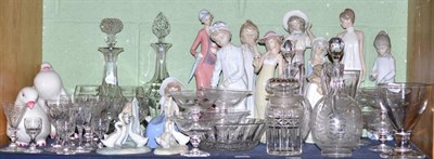 Lot 147 - A shelf including assorted Nao figures, glass sundae dishes, two similar decanters and...