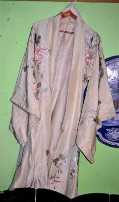 Lot 186 - An early 20th century Japanese cream silk decorative kimono with pink silk floral embroidery