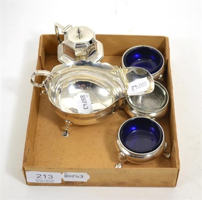 Lot 213 - A silver sauce boat, three circular silver salts with glass liners and a hinged condiment (5)