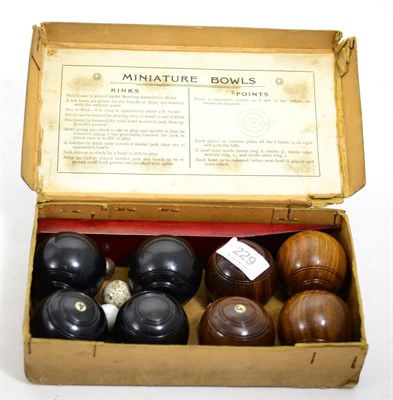 Lot 229 - A boxed miniature bowls game with ebony and lignum vitae bowls