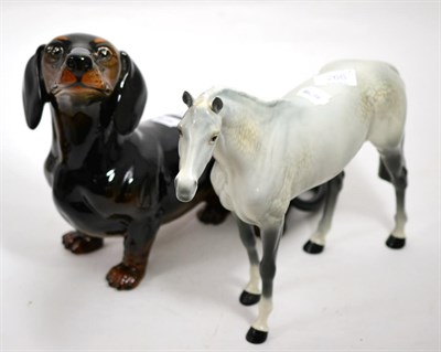 Lot 266 - Beswick large figure of a seated dachshound, and a grey Hunter (2)