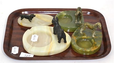 Lot 327 - A group of four cold painted bronze models of dogs mounted on hardstone ashtrays