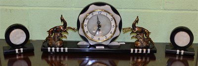 Lot 343 - An Art Deco style, onyx and gilt metal clock garniture (3)