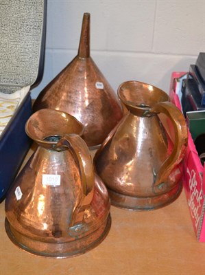 Lot 1010 - A Victorian copper distillery funnel and two copper one gallon spirit measures (3)