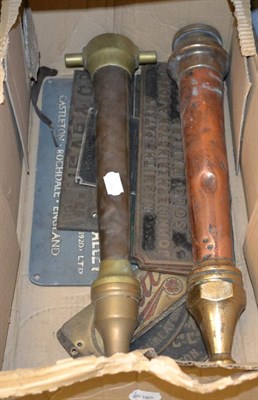 Lot 1043 - Two copper and brass fire nozzles and assorted cast name plates