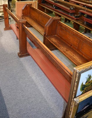 Lot 1050 - A pair of pine church pews with integral kneelers