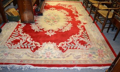 Lot 1054 - A red ground Chinese rug