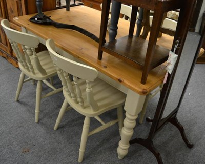 Lot 1061 - A pine table and four chairs