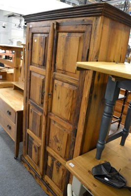 Lot 1062 - A 20th century fruitwood wardrobe with panelled doors opening to reveal four shelves