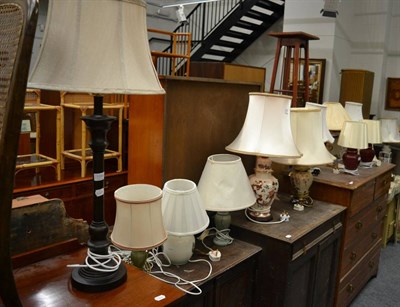 Lot 1066 - Fourteen various modern table lamps, a mirror, a hand bell, a tray and a reniform dressing...