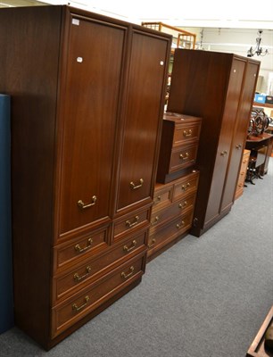 Lot 1075 - A four piece bedroom suite comprising two wardrobes, a bedside chest of drawers and another...