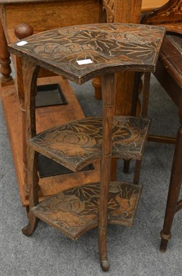 Lot 1077 - An early 20th century far Eastern corner stand with carved lotus flower decoration