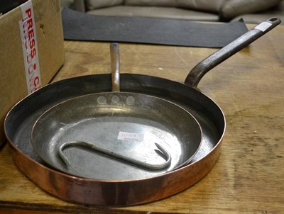 Lot 1099 - A copper frying pan and similar sautee pan (2)