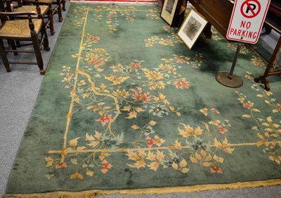 Lot 1205 - A large green carpet with floral pattern