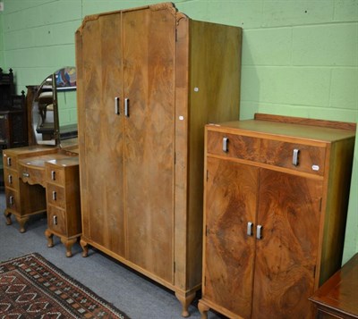 Lot 1221 - An Art Deco four piece walnut bedroom suite comprising of tallboy, a bed, wardrobe and dressing...