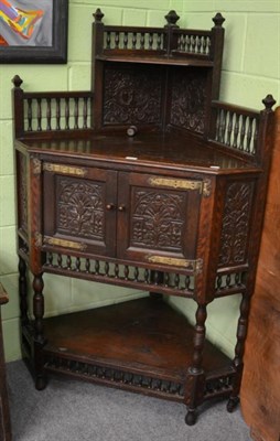 Lot 1223 - A carved oak free standing corner cupboard