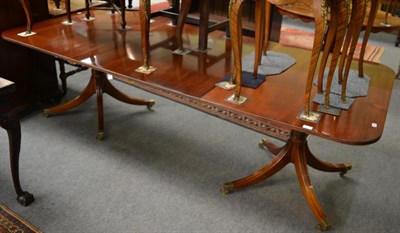 Lot 1254 - A mahogany twin pillar dining table with two additional leaves