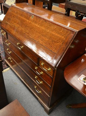 Lot 1255 - A Georgian oak bureau