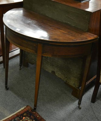 Lot 1262 - A George III mahogany and crossbanded foldover tea table, circa 1780, raised on square tapering...