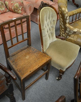 Lot 1270 - A Victorian carved walnut nursing chair and a provincial oak dining chair (2)