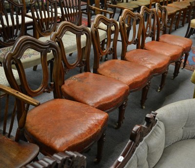 Lot 1281 - A set of six Victorian mahogany balloon-back dining chairs with leather seats, fluted legs to...