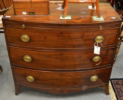 Lot 1297 - A Georgian mahogany bow fronted chest of drawers with brushing slide