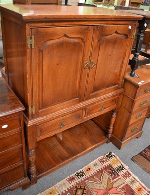 Lot 1310 - An oak Bevan & Funnell two door cabinet on stand with twin fielded doors over two drawers