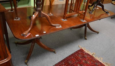 Lot 1322 - A reproduction mahogany twin pillar dining table in George III style, of rounded rectangular...