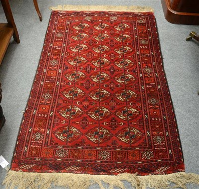 Lot 1323 - Tekke rug, North West Afghanistan, the crimson field with three rows of quartered güls...