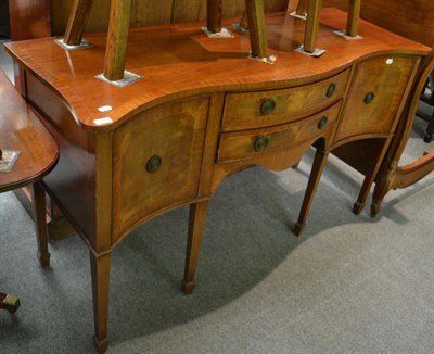 Lot 1327 - A reproduction mahogany serpentine shaped sideboard in George III style, with two frieze...