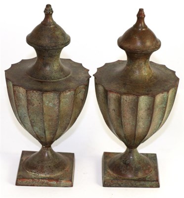 Lot 11 - A pair of cast tobacco jars and cover of fluted urn form