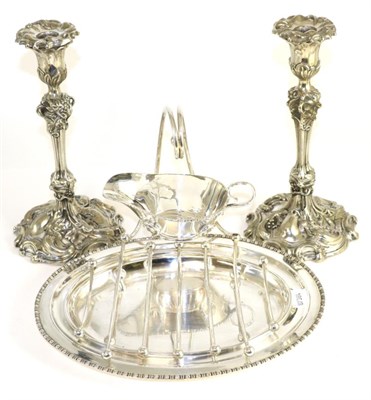 Lot 13 - A pair of Victorian electroplated candlesticks by Elkington; together with a plated asparagus dish