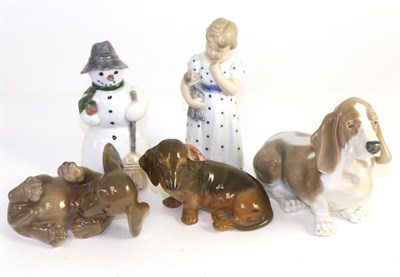 Lot 24 - Five Royal Copenhagen figures including three dogs, a snowman and a young girl
