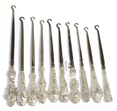 Lot 72 - Ten assorted silver mounted button hooks, each with rococo style C scroll decoration to the...