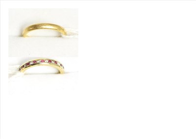 Lot 78 - An 18ct gold gem set eternity ring and a 22ct gold band