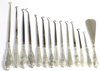 Lot 101 - Thirteen assorted silver button hooks and a shoe horn, comprising six decorated with cherubs, three
