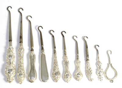 Lot 102 - Ten assorted small/miniature silver mounted button hooks, each with rococo style c scroll...