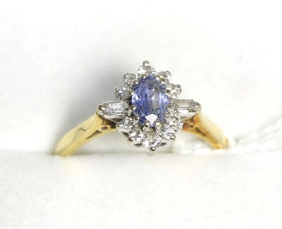 Lot 105 - An 18ct gold sapphire and diamond cluster ring