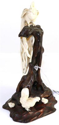 Lot 135 - An early 20th century carved ivory group of chickens on a wood stand
