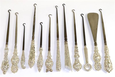 Lot 149 - A collection of eleven assorted good silver button hooks, with pierced, naturalistic, rococo,...