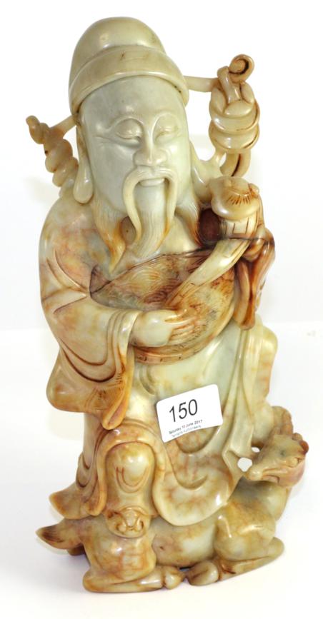 Lot 150 - A Chinese carved hardstone figure of an immortal