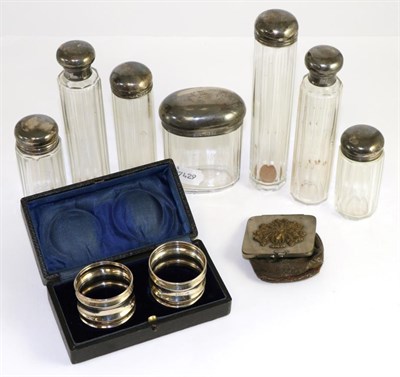 Lot 151 - Seven silver topped toilet bottles, a pair of napkin rings and a purse