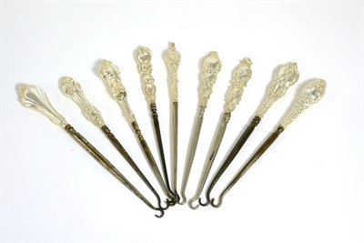 Lot 162 - Ten assorted silver mounted button hooks, each with rococo style C scroll decoration or Neo...